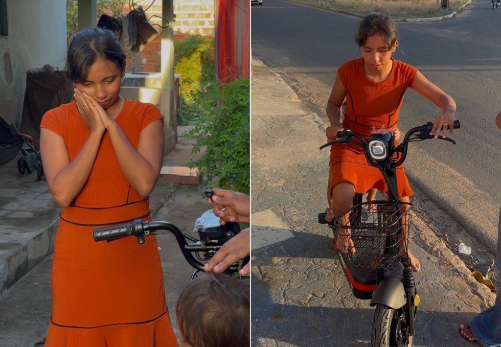 Mãe que levava filho de 2 anos para escola amarrado à cintura ganha bicicleta elétrica no TO; VÍDEO
